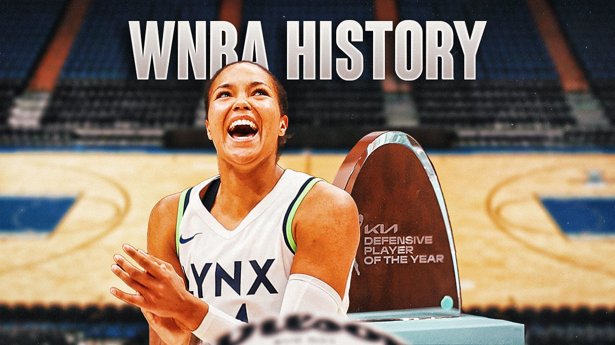 Minnesota Lynx forward Napheesa Collier smiling with a photo of the WNBA Defensive Player of the Year trophy beside her. Above her, there's text that says WNBA History.
