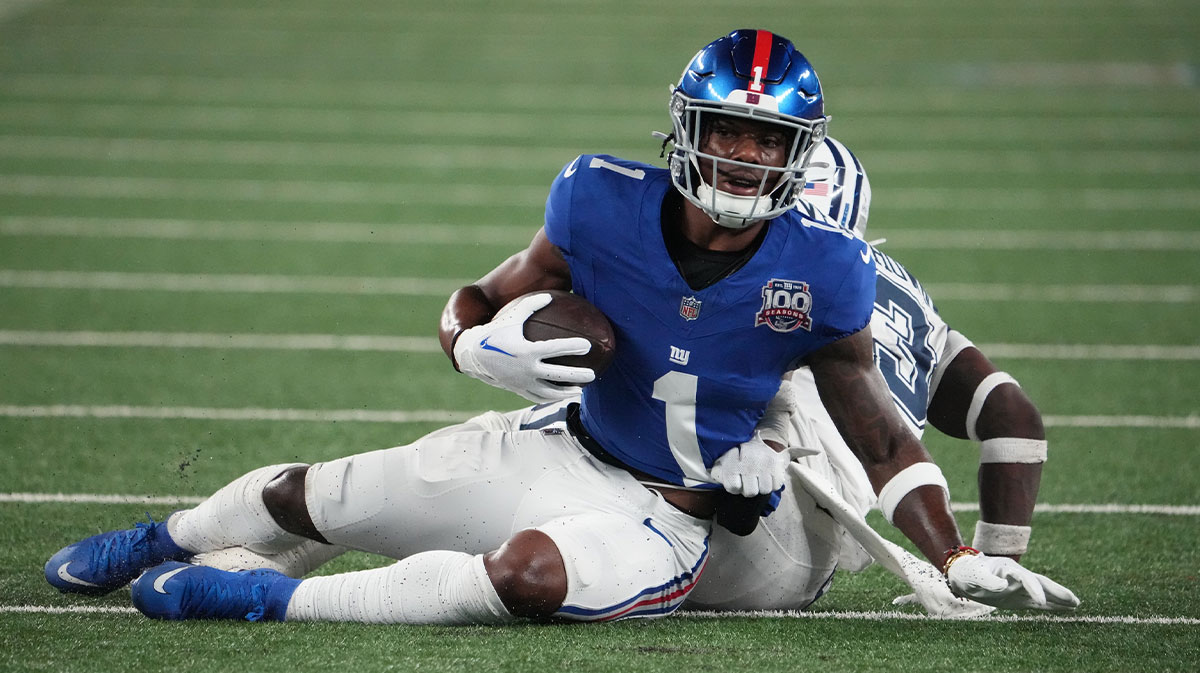 New York Giants wide receiver Malik Nabers (1) on a short gain against Dallas Cowboys linebacker DeMarvion Overshown (13) during the first half at MetLife Stadium.