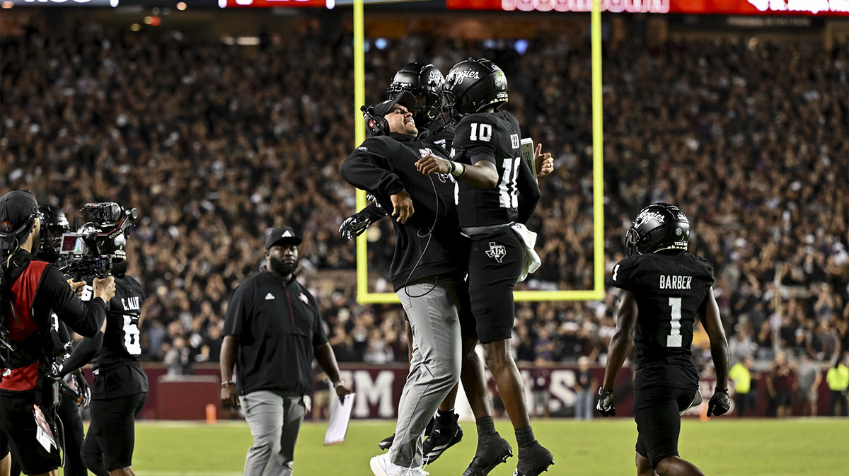 Texas A&M Aggies quarterback Marcel Reed (10) celebrates after scoring a touchdown with Offensive Coordinator/Quarterbacks coach Collin Klein in the third quarter against the LSU Tigers at Kyle Field.