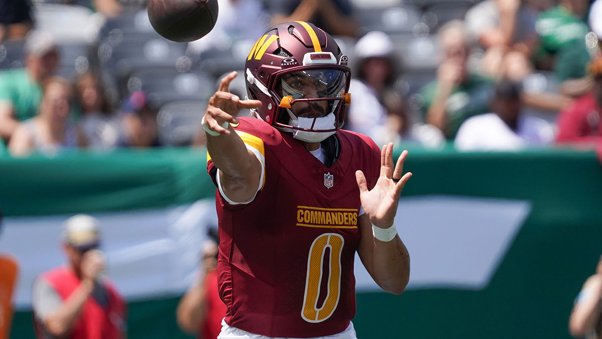 Washington Commanders quarterback Marcus Mariota (0) passes during the first quarter against the New York Jets at MetLife Stadium.