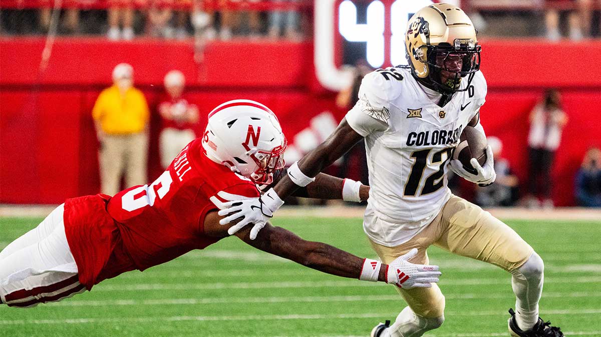 olorado Buffaloes wide receiver Travis Hunter (12) stiff arms Nebraska Cornhuskers defensive back Tommi Hill (6) during the second quarter at Memorial Stadium.
