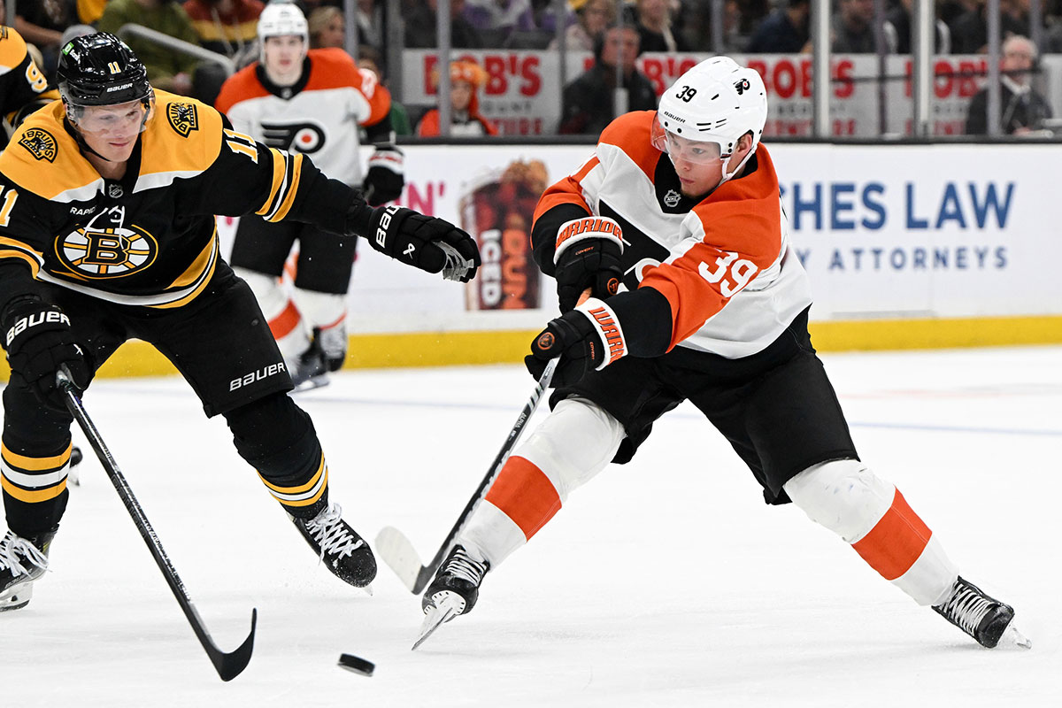 Philadelphia Flyers right wing Matvei Michkov (39) takes in shot in front of Boston Bruins center Trent Frederic (11) during the second period at the TD Garden.