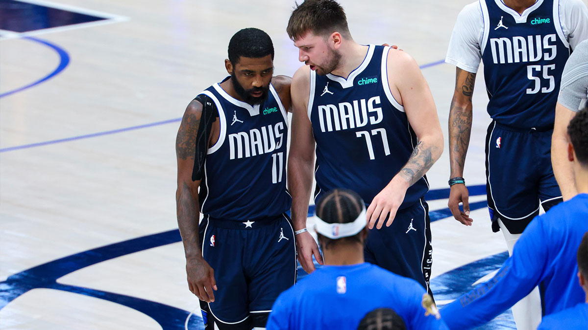 Dallas Mavericks guard Kyrie Irving (11) reacts with Dallas Mavericks guard Luka Doncic (77) during the second half against the Boston Celtics during game four of the 2024 NBA Finals at American Airlines Center