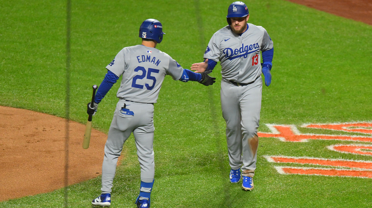 Los Angeles Dodgers third base Max Muncy (13) reacts with outfielder Tommy Edman (25) after scroing a run against the New York Mets in the second inning during game three of the NLCS for the 2024 MLB playoffs at Citi Field.