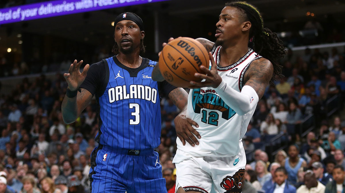 Memphis Grizzlies guard Ja Morant (12) passes the ball as Orlando Magic guard Kentavious Caldwell-Pope (3) defends during the second half at FedExForum.