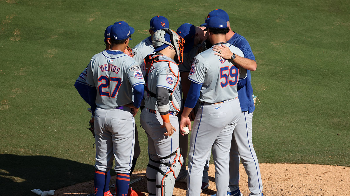 New York Mets manager Carlos Mendoza (64) makes a visit to the mound against the Los Angeles Dodgers in the eighth inning during game two of the NLCS for the 2024 MLB Playoffs at Dodger Stadium.