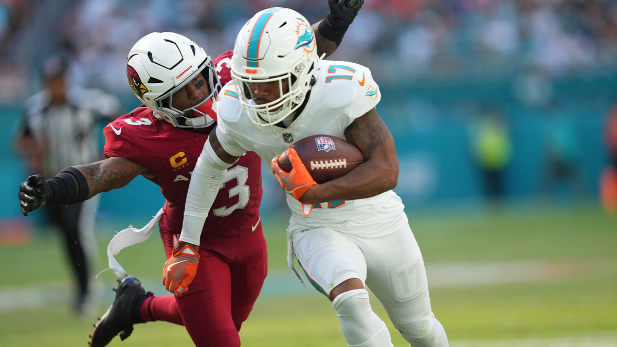 Miami Dolphins wide receiver Jaylen Waddle (17) catches a pass in the fourth quarter as Arizona Cardinals safety Budda Baker (3) closes in on the play at Hard Rock Stadium.
