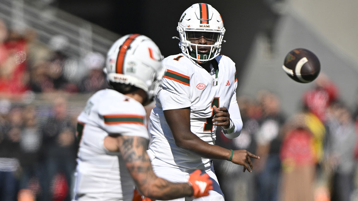 Oct 19, 2024; Louisville, Kentucky, USA; Miami Hurricanes quarterback Cam Ward (1) passes to wide receiver Xavier Restrepo (7) against the Louisville Cardinals during the first quarter at L&N Federal Credit Union Stadium. Mandatory Credit: Jamie Rhodes-Imagn Images