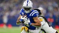 Sep 29, 2024; Indianapolis, Indiana, USA; Indianapolis Colts wide receiver Michael Pittman Jr. (11) is tackled by Pittsburgh Steelers cornerback Donte Jackson (26) during the second quarter at Lucas Oil Stadium.