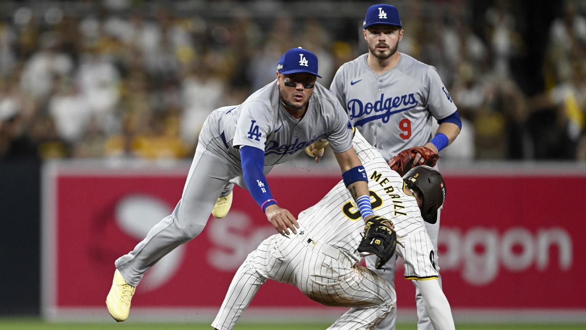 Los Angeles Dodgers shortstop Miguel Rojas (11) throws late to first after not forcing out San Diego Padres outfielder Jackson Merrill (3) at second in the second inning during game three of the NLDS for the 2024 MLB Playoffs at Petco Park.