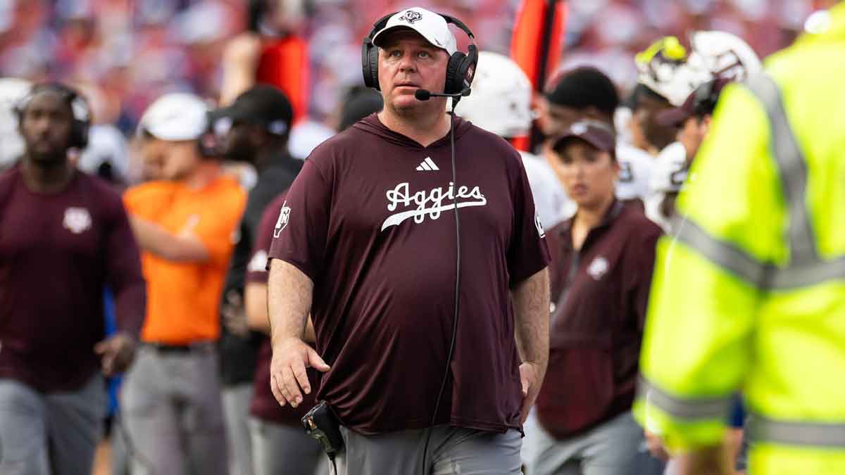 Texas A&M Aggies head coach Mike Elko walks the sideline against the Florida Gators during the first half at Ben Hill Griffin Stadium.