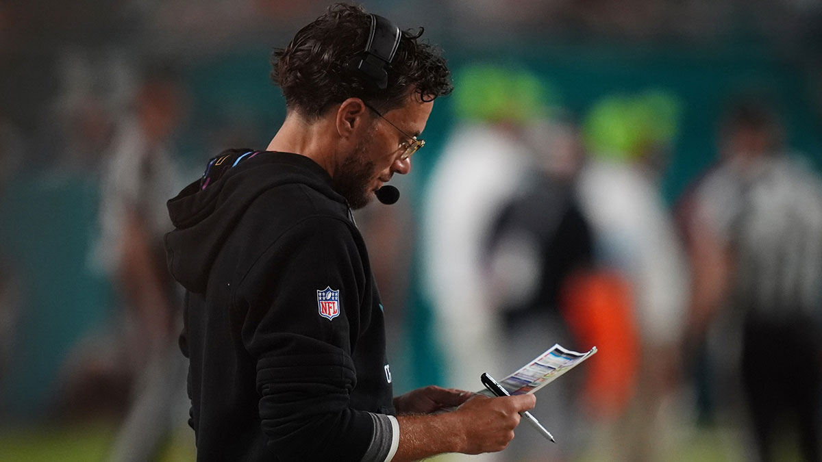Miami Dolphins head coach Mike McDaniel looks over his play card during the second half against the Tennessee Titans at Hard Rock Stadium.