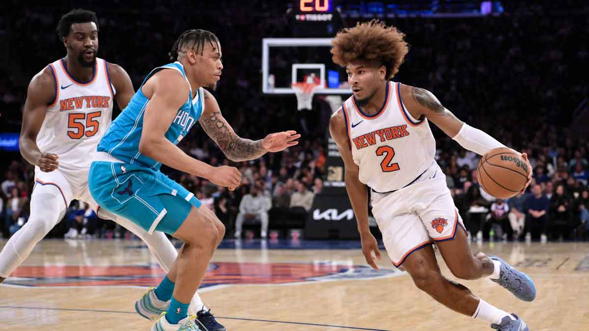 Oct 15, 2024; New York, New York, USA; New York Knicks guard Miles McBride (2) drives to the basket while being defended by Charlotte Hornets forward Keyontae Johnson (7) during the first half at Madison Square Garden. Mandatory Credit: John Jones-Imagn Images