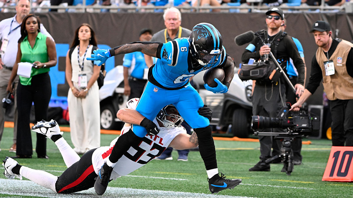 Carolina Panthers running back Miles Sanders (6) is knocked out of bounds by Atlanta Falcons linebacker Nate Landman (53) in the second quarter at Bank of America Stadium.
