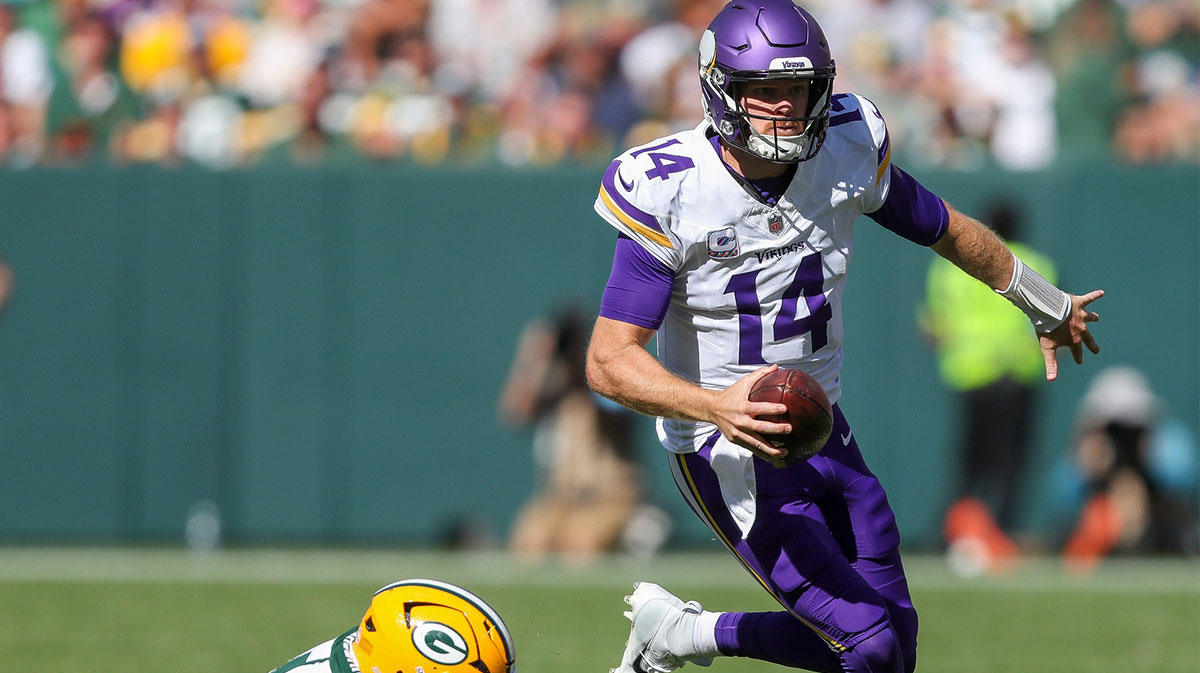 Minnesota Vikings quarterback Sam Darnold (14) escapes from Green Bay Packers defensive end Kingsley Enagbare (55) on Sunday, September 29, 2024, at Lambeau Field in Green Bay, Wis. The Vikings won the game, 31-29. Tork Mason/USA TODAY NETWORK-Wisconsin