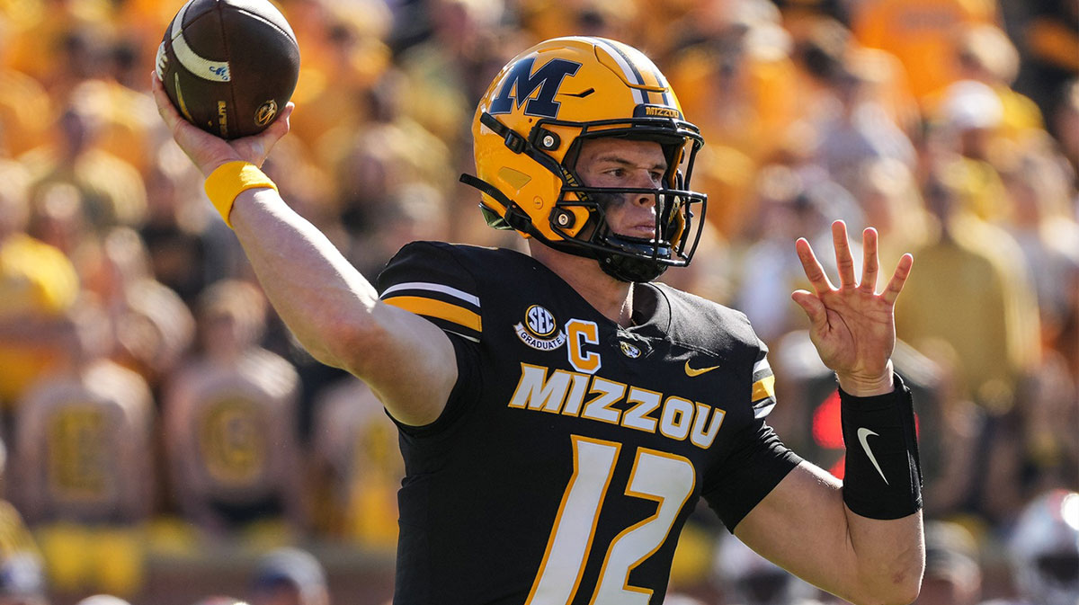 Missouri Tigers quarterback Brady Cook (12) throws a pass during the first half against the Auburn Tigers at Faurot Field at Memorial Stadium.