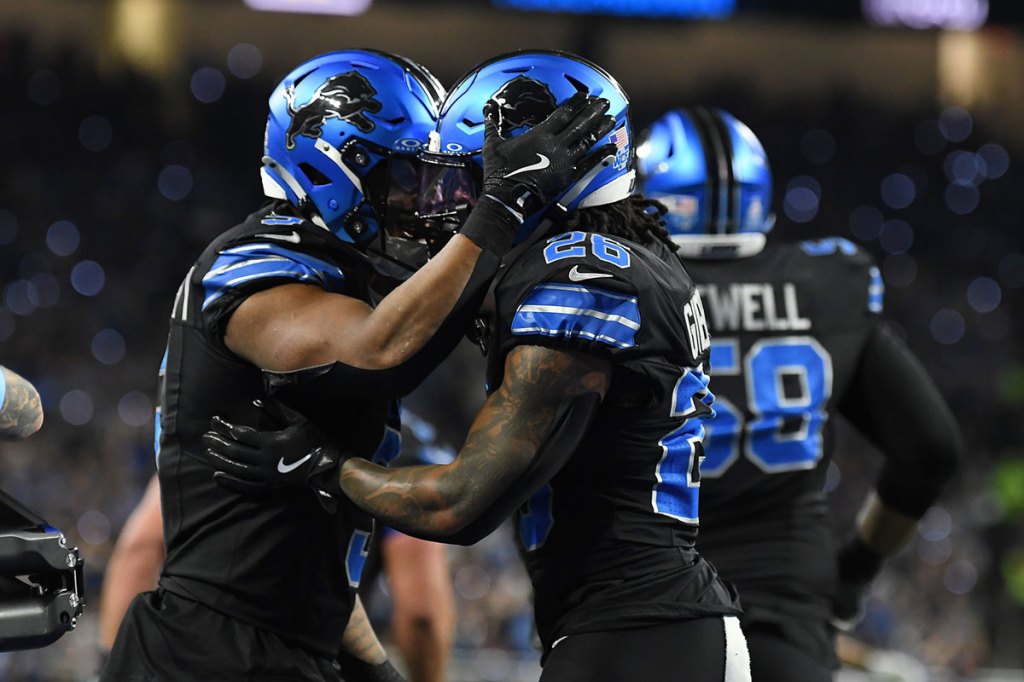 Detroit Lions running back Jahmyr Gibbs (26) celebrates with running back David Montgomery (5) after scoring a touchdown against the Seattle Seahawks in the second quarter at Ford Field.