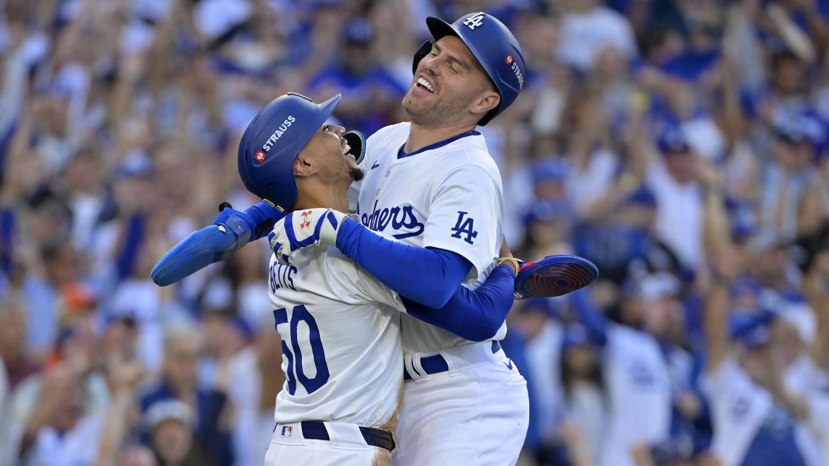 Los Angeles Dodgers first base Freddie Freeman (5) reacts with shortstop Mookie Betts (50) after scoring against the New York Mets during the first inning in game one of the NLCS for the 2024 MLB Playoffs at Dodger Stadium.