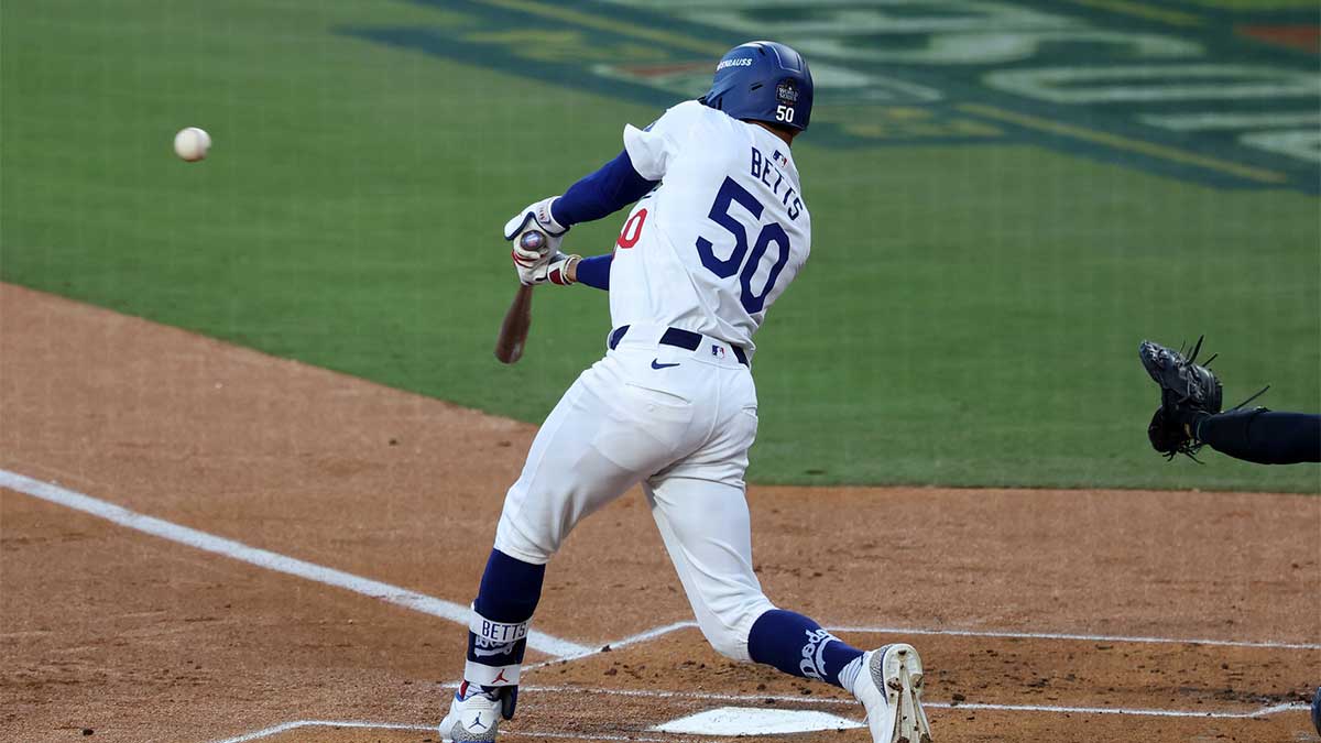 Oct 26, 2024; Los Angeles, California, USA; Los Angeles Dodgers outfielder Mookie Betts (50) hits a single against the New York Yankees in the first inning for game two of the 2024 MLB World Series at Dodger Stadium.