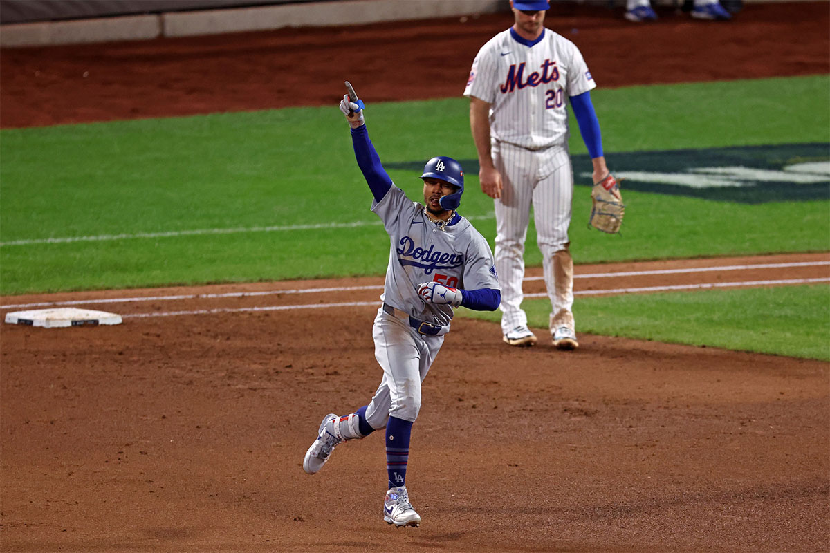 Los Angeles Dodgers shortstop Mookie Betts (50) reacts after hitting a two run home run against New York Mets pitcher Phil Maton (88) in the sixth inning during game four of the NLCS for the 2024 MLB playoffs at Citi Field. 