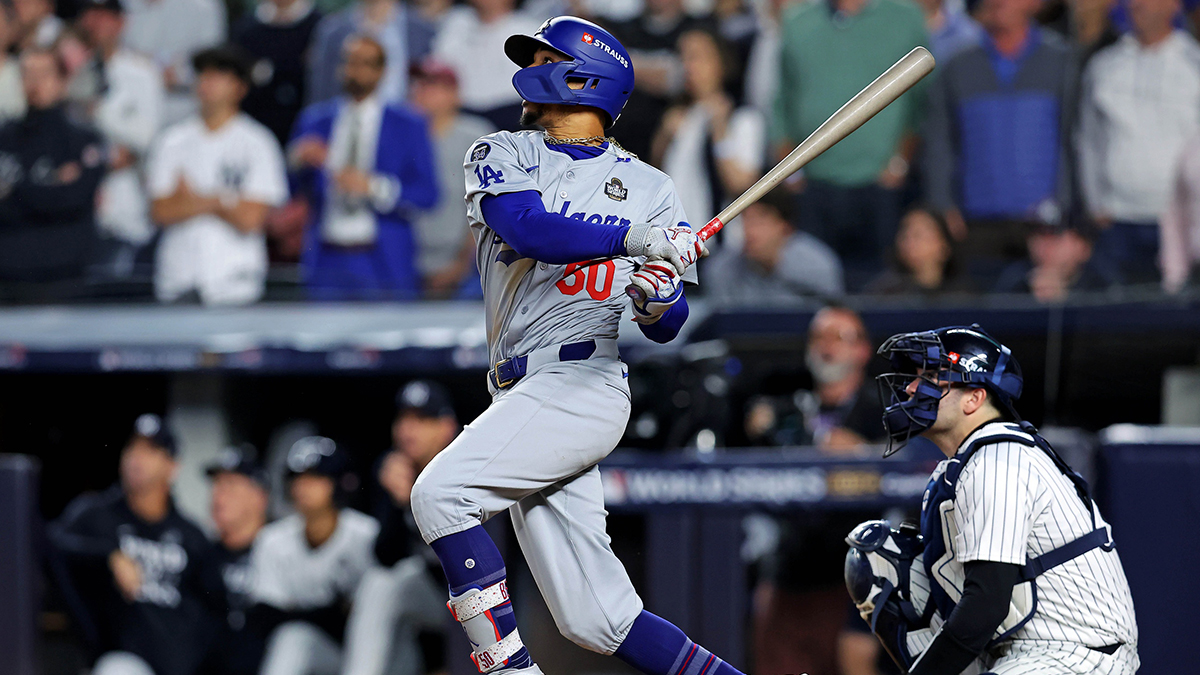 Oct 30, 2024; New York, New York, USA; Los Angeles Dodgers shortstop Mookie Betts (50) hits a sacrifice fly during the eighth inning against the New York Yankees in game four of the 2024 MLB World Series at Yankee Stadium.