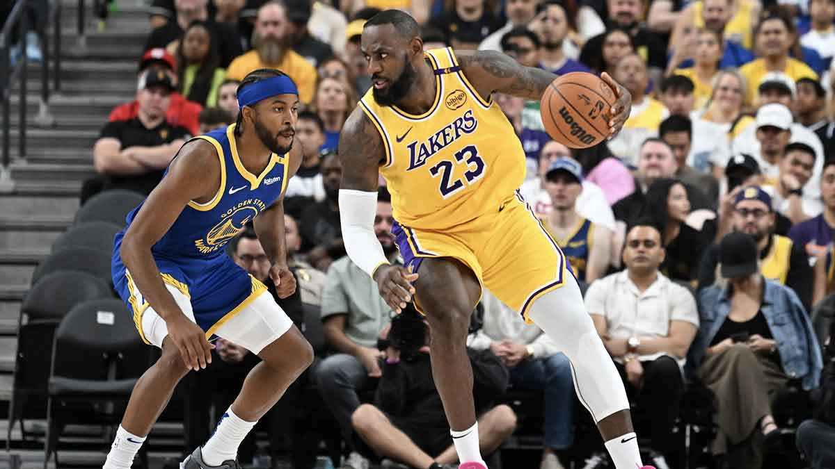 Golden State Warriors guard Moses Moody (4) defends against Los Angeles Lakers forward LeBron James (23) in the second quarter at T-Mobile Arena.