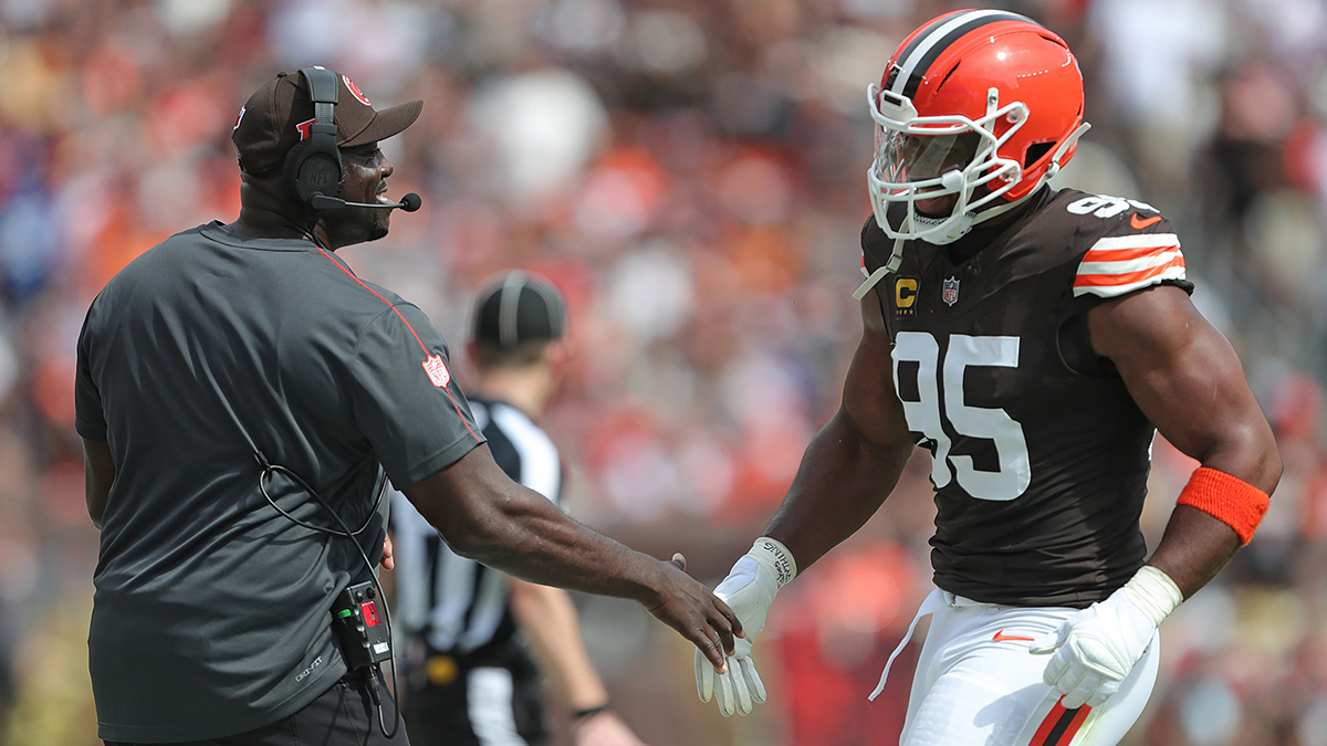 Cleveland Browns defensive line coach Jacques Cesaire, left, celebrates with defensive end Myles Garrett (95) during the first half of an NFL football game at Huntington Bank Field, Sunday, Sept. 22, 2024, in Cleveland, Ohio.