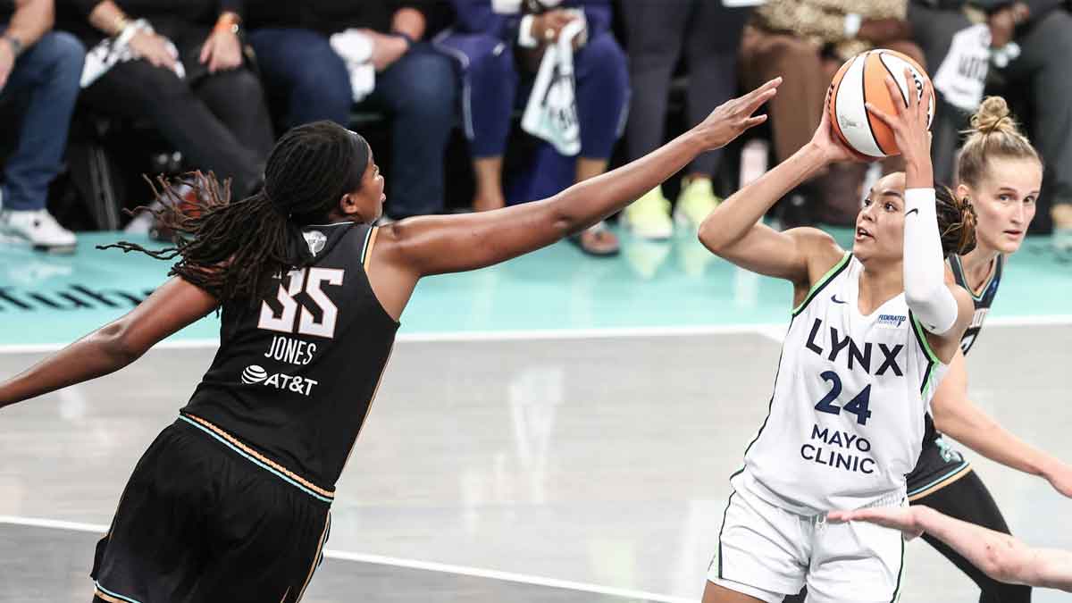 Minnesota Lynx forward Napheesa Collier (24) shoots as New York Liberty forward Jonquel Jones (35) defends in overtime at Barclays Center.