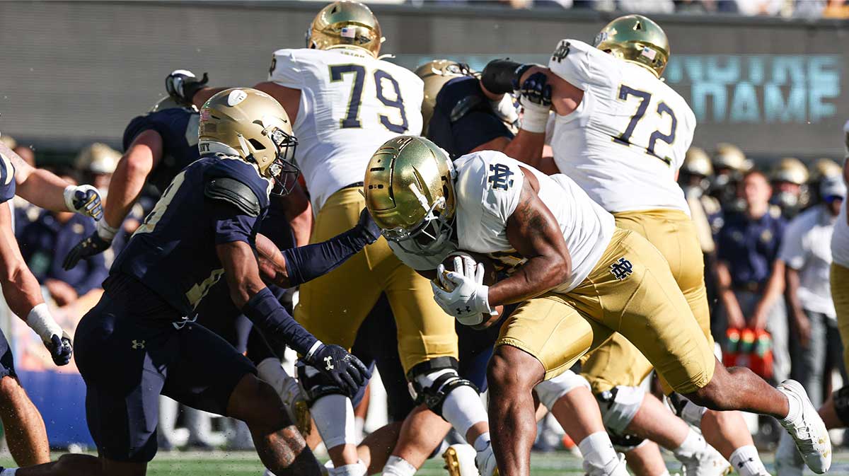 Notre Dame Fighting Irish running back Kedren Young (21) carries the ball after the game Navy Midshipmen safety Rayuan Lane III (18) during the second half at MetLife Stadium.