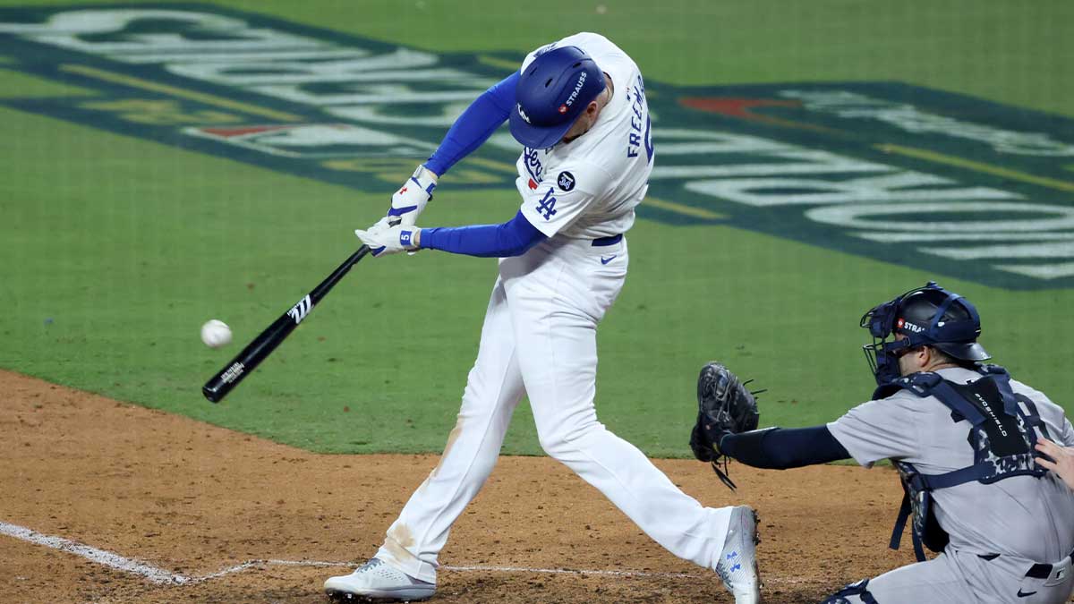 Los Angeles Dodgers first baseman Freddie Freeman (5) hits a grand slam home run in the tenth inning against the New York Yankees during game one of the 2024 MLB World Series at Dodger Stadium.