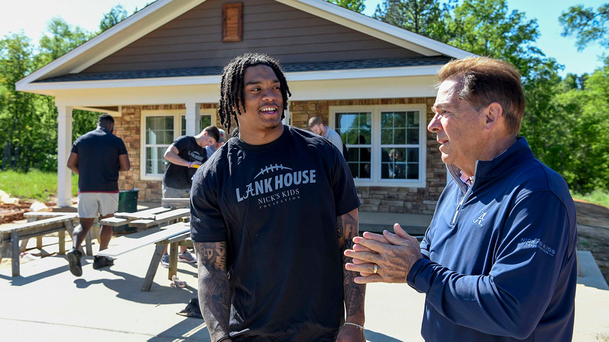 Alabama defensive back Malachi Moore talks with former coach Nick Saban at the LANK House, a tribute to the 2023 Crimson Tide football team, funded by the Nick’s Kids Foundation for Habitat for Humanity.