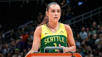 WNBA Seattle Storm player Nika Mühl with a sad/neutral expression and the injury symbol