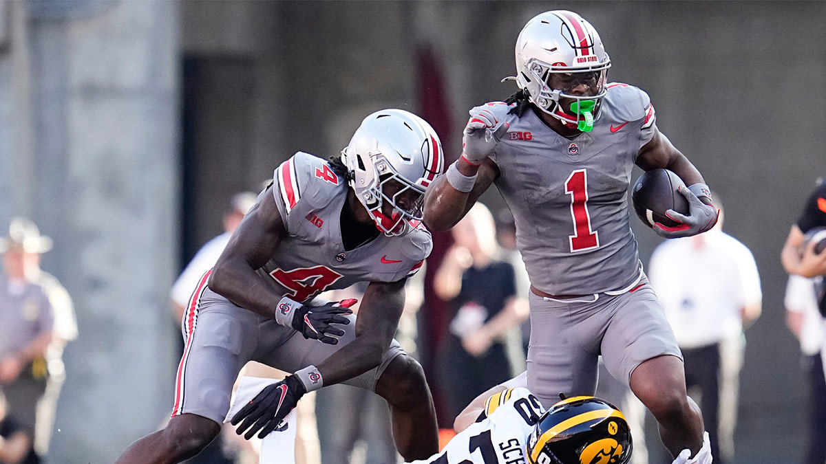 Iowa Hawkeyes defensive back Quinn Schulte tackles Ohio State Buckeyes running back Quinshon Judkins.