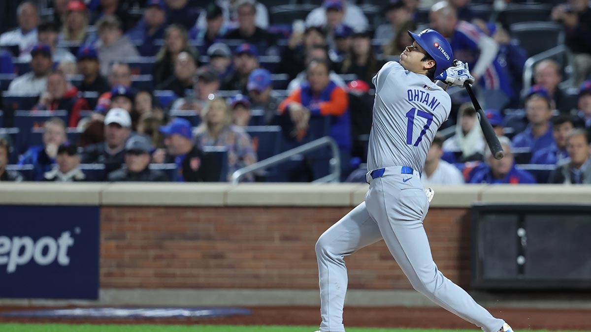 Los Angeles Dodgers two-way player Shohei Ohtani (17) hits a single in the fourth inning against the New York Mets during game five of the NLCS for the 2024 MLB playoffs at Citi Field. 