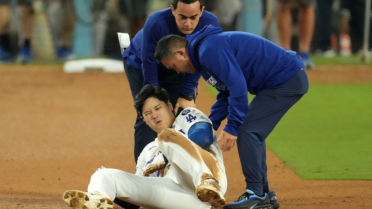 Los Angeles Dodgers designated hitter Shohei Ohtani (17) reacts after injuring his shoulder against the New York Yankees in the seventh inning for game two of the 2024 MLB World Series at Dodger Stadium.