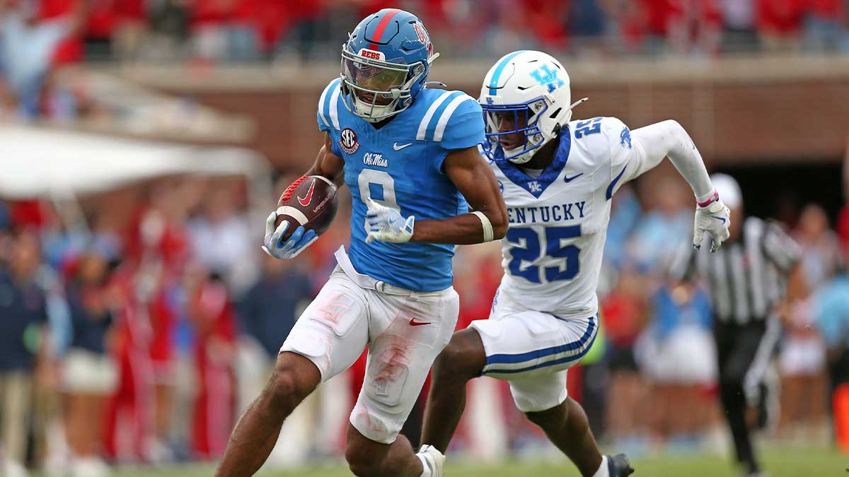 Sep 28, 2024; Oxford, Mississippi, USA; Mississippi Rebels wide receiver Tre Harris (9) runs after a catch for a first down as Kentucky Wildcats defensive back Jordan Lovett (25) pursues during the second half at Vaught-Hemingway Stadium. Mandatory Credit: Petre Thomas-Imagn Images