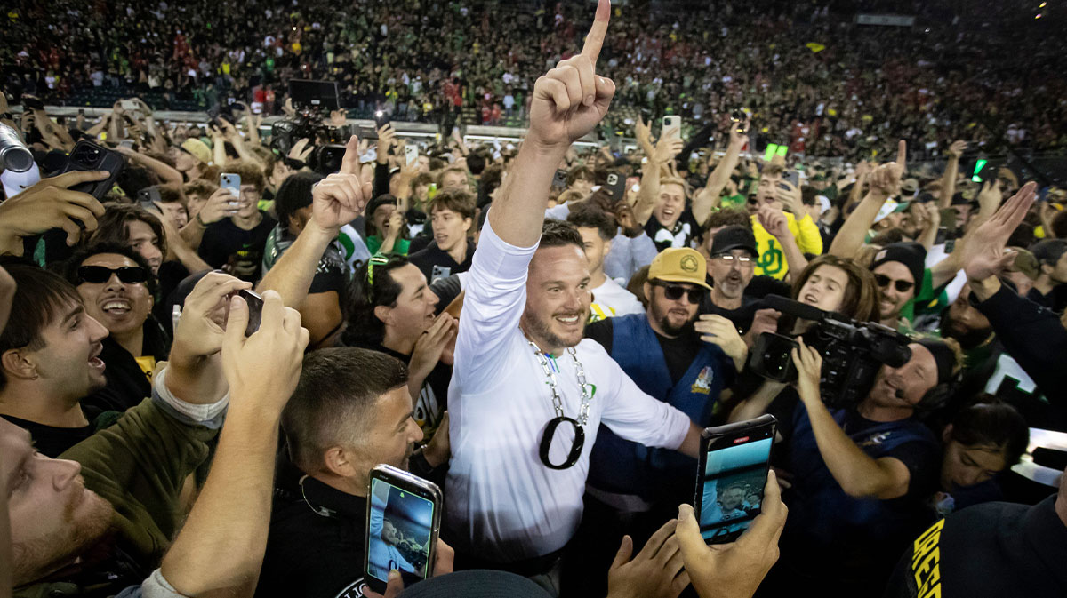 Oregon Ducks head coach Dan Lanning celebrates amid a crowd of fans on the field as the No. 3 Oregon Ducks knock off the No. 2 Ohio State Buckeyes 32-31 Saturday, Oct. 12, 2024 at Autzen Stadium in Eugene, Ore.