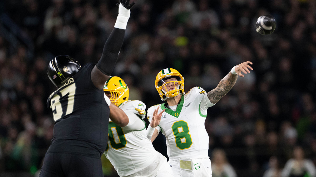 Oregon Ducks quarterback Dillon Gabriel (8) throws a pass in front of Purdue Boilermakers defensive lineman Jamarrion Harkless (97) at Ross-Ade Stadium.