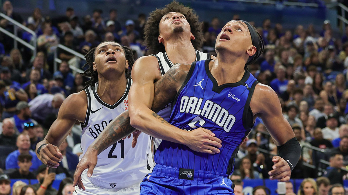 Orlando Magic forward Paolo Banchero (5), Brooklyn Nets forward Noah Clowney (21) and forward Jalen Wilson (22) look for the rebound during the second half at Kia Center.