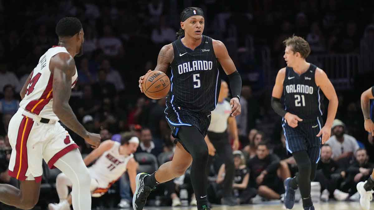 Orlando Magic forward Paolo Banchero (5) brings the ball up the court against the Miami Heat during the second half at Kaseya Center.