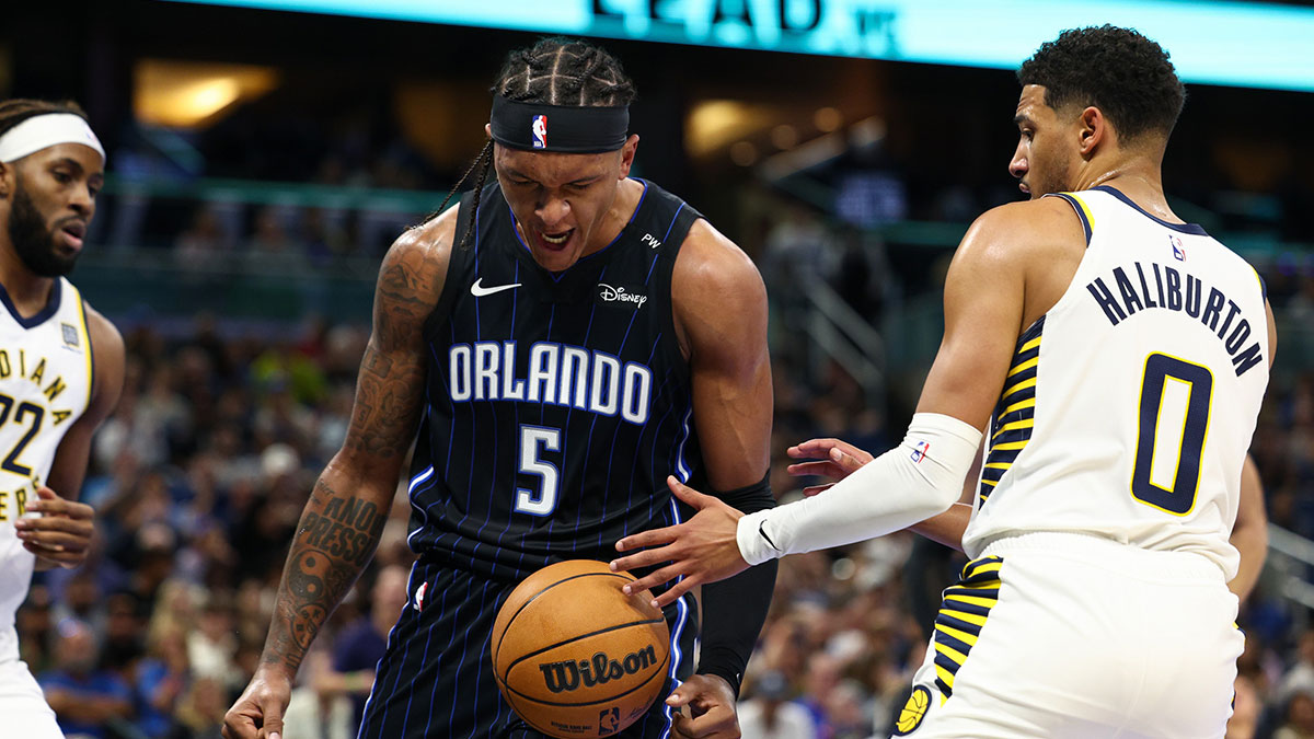 Orlando Magic forward Paolo Banchero (5) reacts after dunking the ball against the Indiana Pacers in the first quarter at Kia Center.
