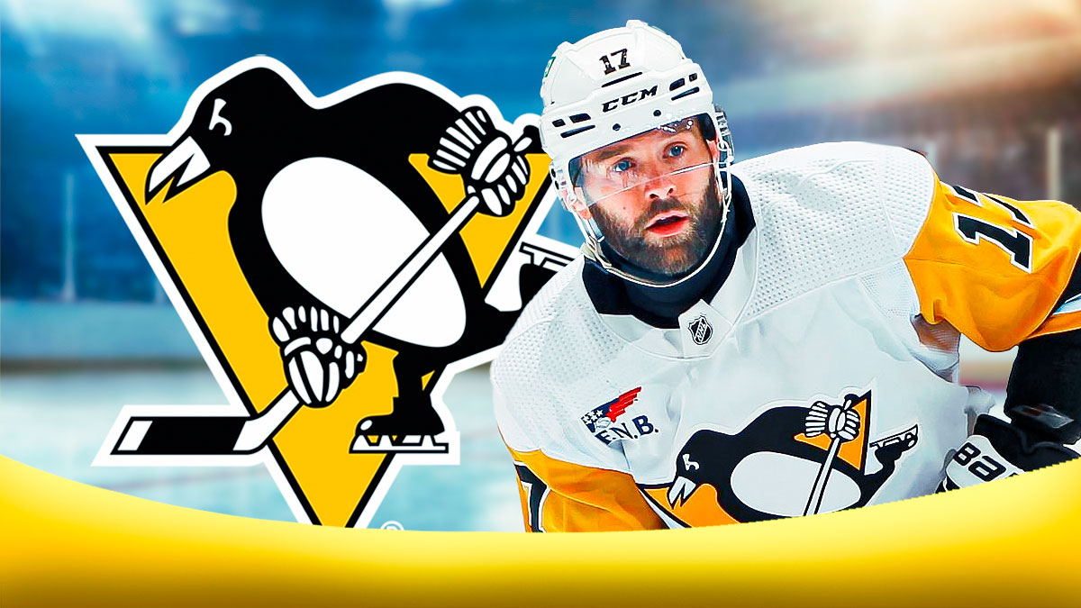 Bryan Rust looking happy, Pittsburgh Penguins logo, hockey rink in background