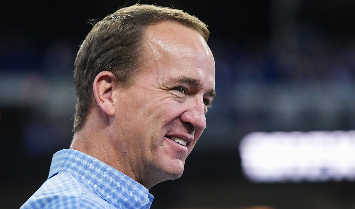 Former Indianapolis Colts player Peyton Manning talks to former teammates and friends on the field Sunday, Oct. 20, 2024, ahead of the game against the Miami Dolphins at Lucas Oil Stadium in Indianapolis.