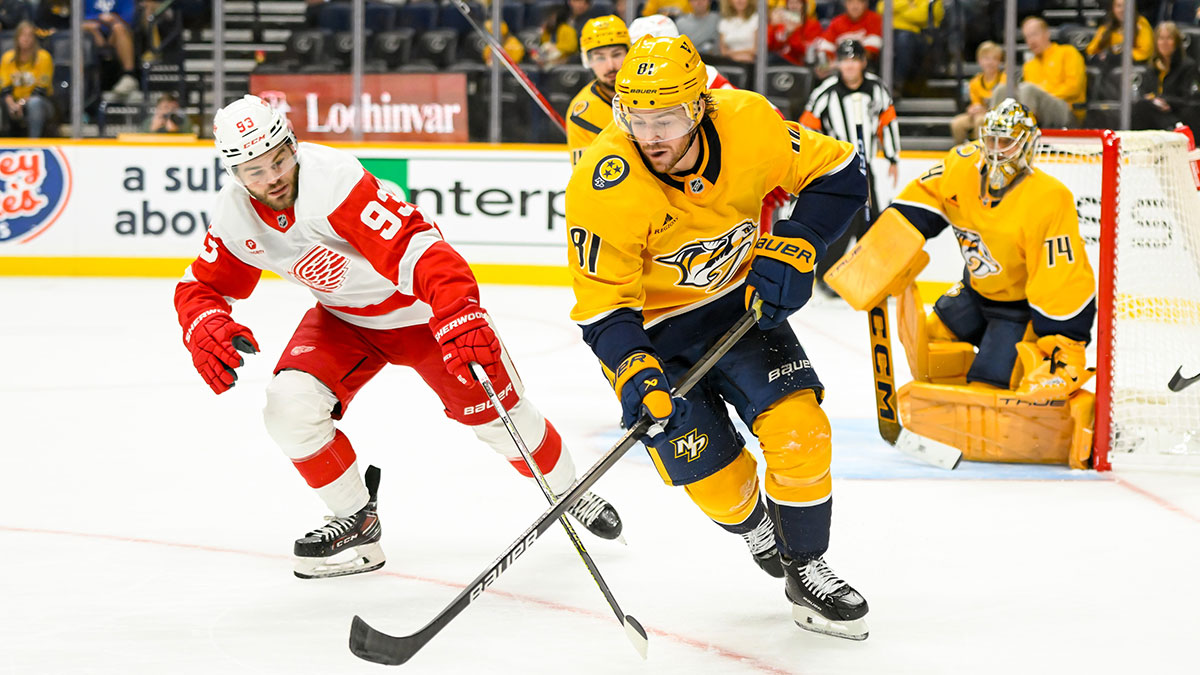 Nashville Predators center Jonathan Marchessault (81) skates while Detroit Red Wings right wing Alex DeBrincat (93) shoots the puck during the second period at Bridgestone Arena.