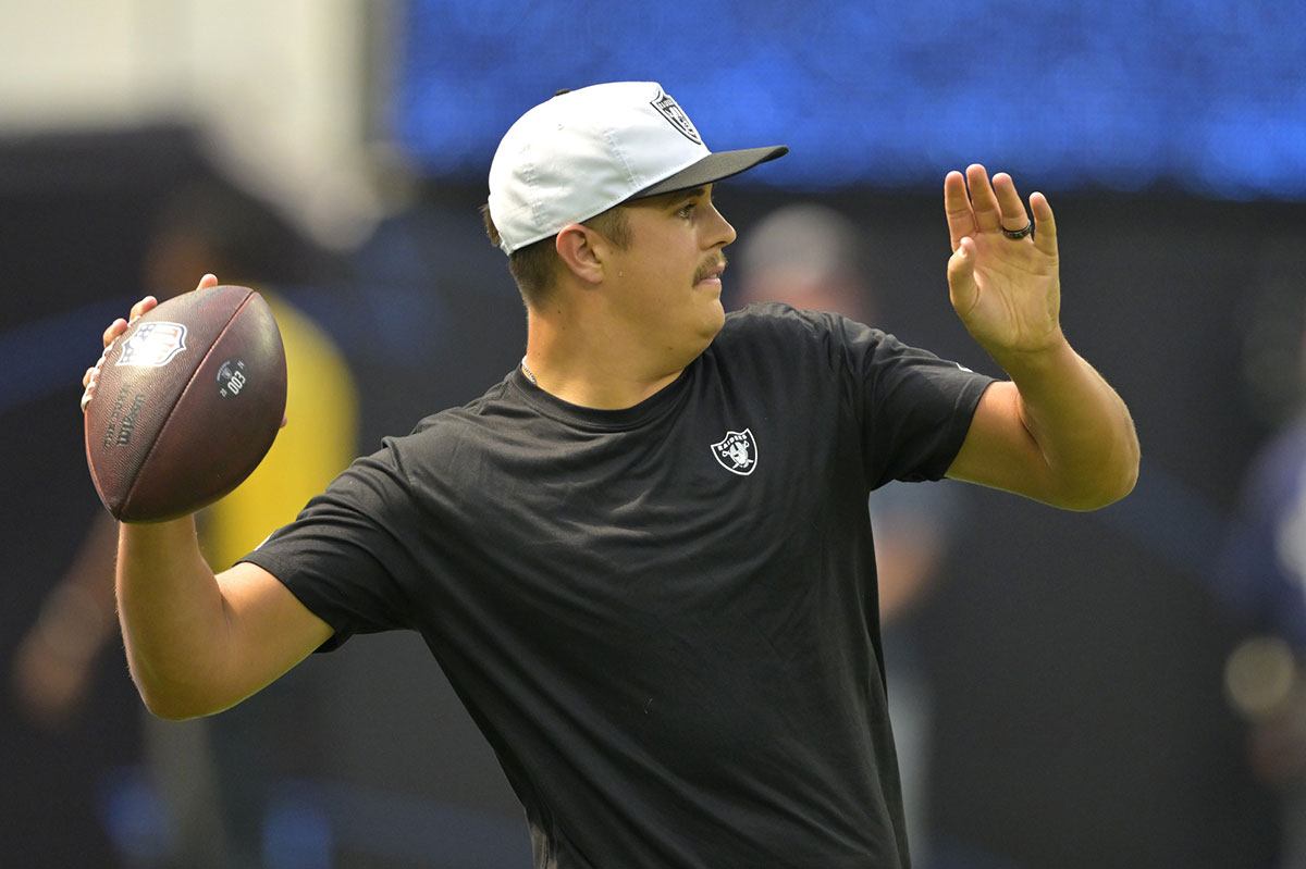 Las Vegas Raiders quarterback Aidan O'Connell (12) warms up prior to the game against the Los Angeles Chargers at SoFi Stadium