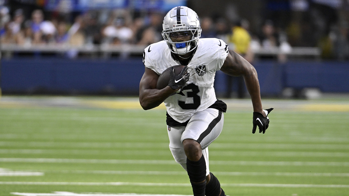 Las Vegas Raiders running back Zamir White (3) runs after a catch against the Los Angeles Rams during the second half at SoFi Stadium.