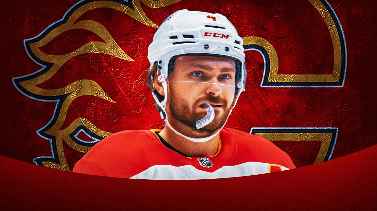 Rasmus Andersson looking stern, Calgary Flames logo, hockey rink in background