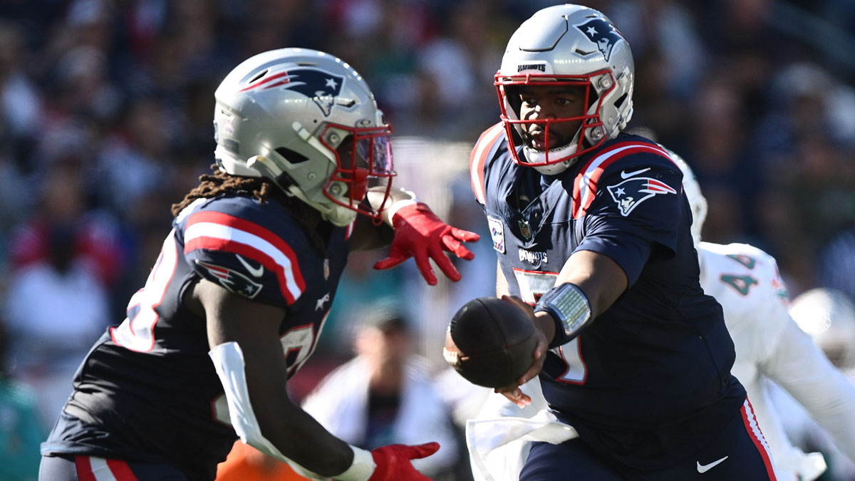 Oct 6, 2024; Foxborough, Massachusetts, USA; New England Patriots quarterback Jacoby Brissett (7) hands the ball off to running back Rhamondre Stevenson (38) during the second half at Gillette Stadium.