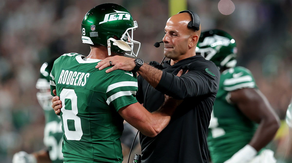New York Jets head coach Robert Saleh hugs quarterback Aaron Rodgers (8) after a touchdown by running back Breece Hall (not pictured) during the second quarter against the New England Patriots at MetLife Stadium.