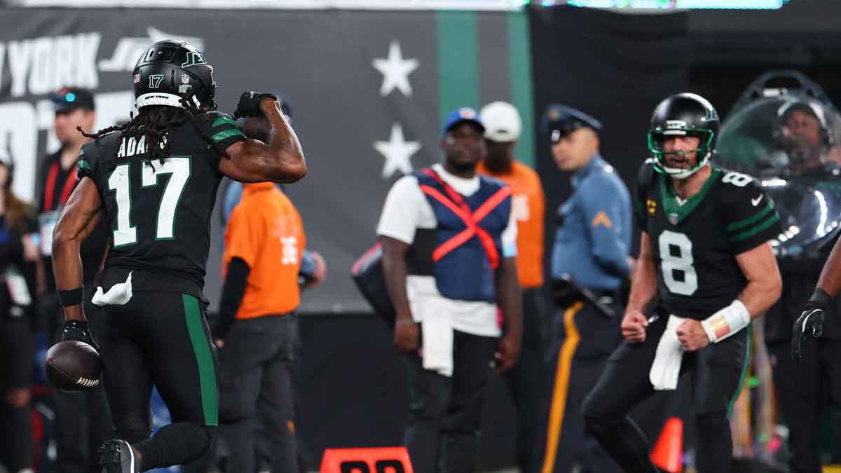 Oct 31, 2024; East Rutherford, New Jersey, USA; New York Jets wide receiver Davante Adams (17) and New York Jets quarterback Aaron Rodgers (8) celebrate a touchdown against the Houston Texans during the second half at MetLife Stadium.